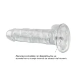 Dildo transparent culcat, cu comutatorul din centrul bazei indicat printr-o săgeată